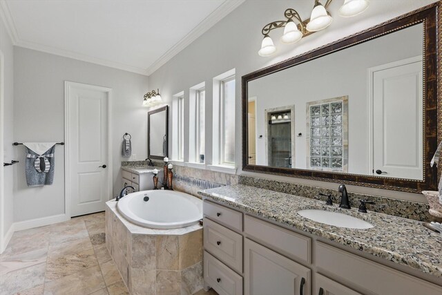 full bathroom with a shower stall, ornamental molding, a sink, and a garden tub