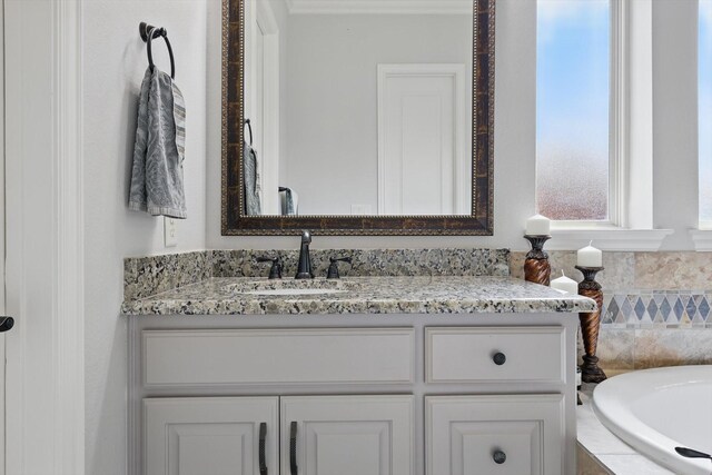 bathroom with vanity and a bath