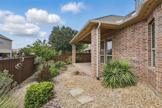 view of yard featuring fence and a patio