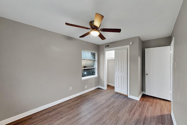 13439 Glenside Dr, Farmers Branch, TX 75234 - unfurnished bedroom with baseboards, wood finished floors, and a closet