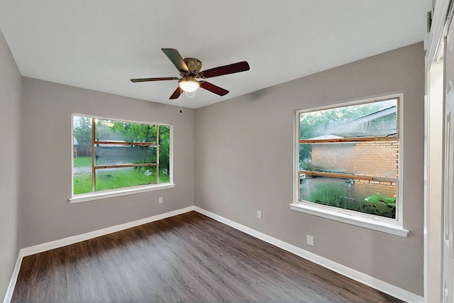 13439 Glenside Dr, Farmers Branch, TX 75234 - empty room with dark wood-style flooring, baseboards, ceiling fan, and a wealth of natural light