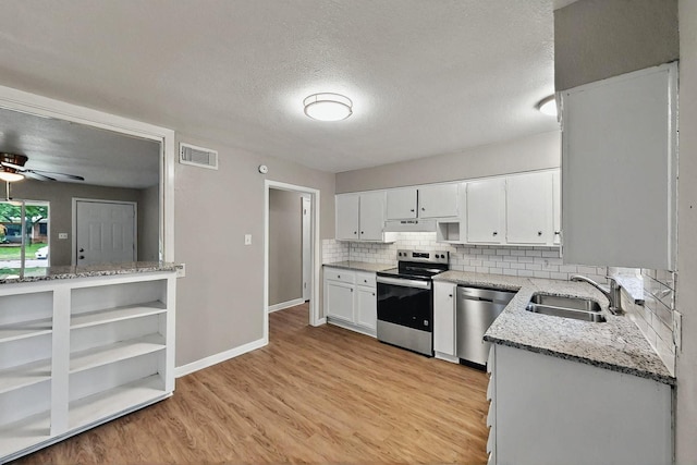 kitchen with backsplash, visible vents, stainless steel appliances, a sink, and under cabinet range hood