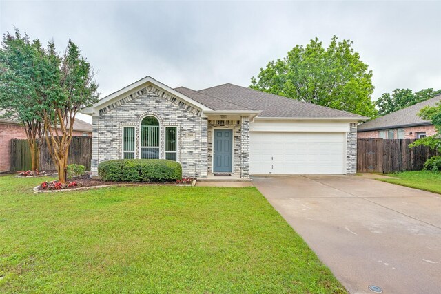 ranch-style home featuring fence, an attached garage, stone siding, a front yard, and driveway