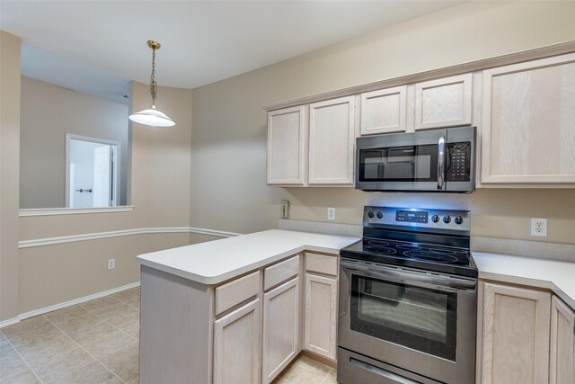 kitchen with pendant lighting, a peninsula, light brown cabinetry, light countertops, and appliances with stainless steel finishes