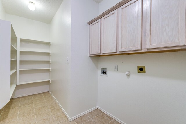 laundry area featuring baseboards, hookup for a washing machine, electric dryer hookup, cabinet space, and hookup for a gas dryer