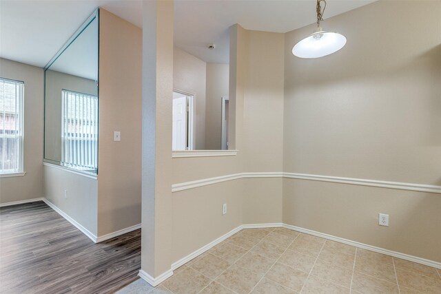 unfurnished room with baseboards