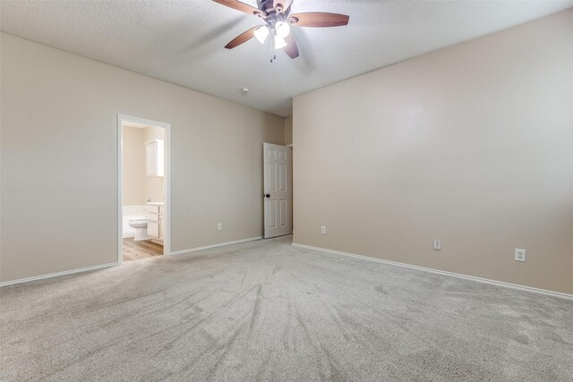 unfurnished room with baseboards, ceiling fan, and light colored carpet