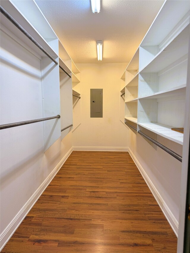 walk in closet featuring dark wood-style flooring and electric panel
