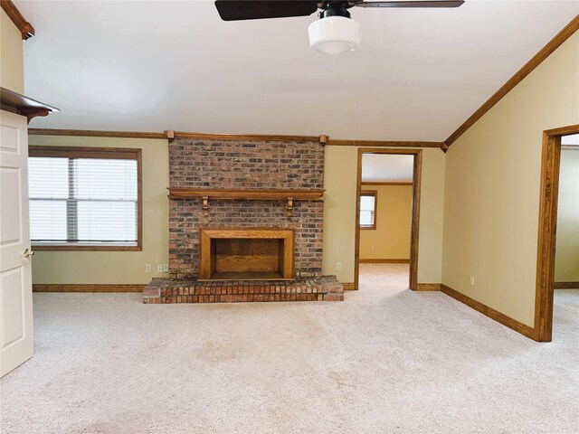 unfurnished living room featuring carpet floors, ornamental molding, a brick fireplace, baseboards, and a ceiling fan