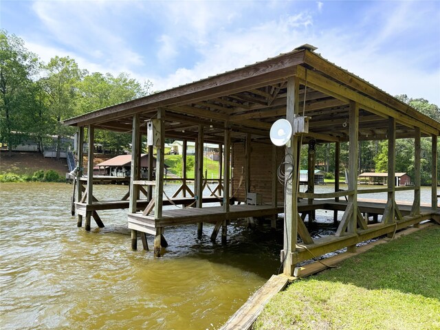 dock area featuring boat lift and a water view