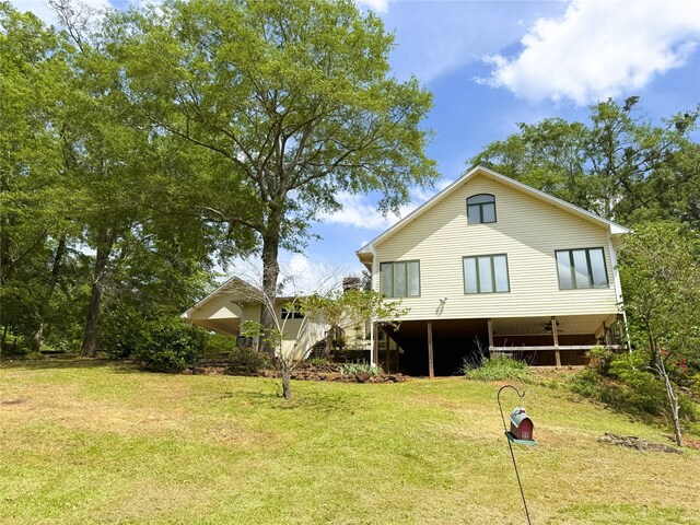 back of property featuring a lawn