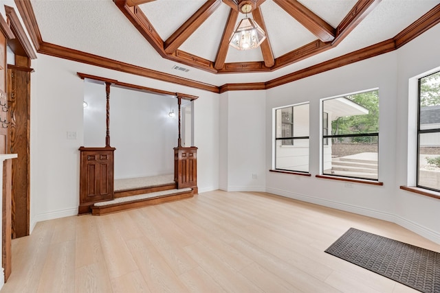 unfurnished room featuring visible vents, light wood-style flooring, crown molding, and a wealth of natural light
