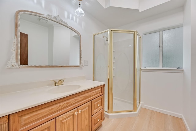 bathroom with vanity, a stall shower, wood finished floors, and visible vents
