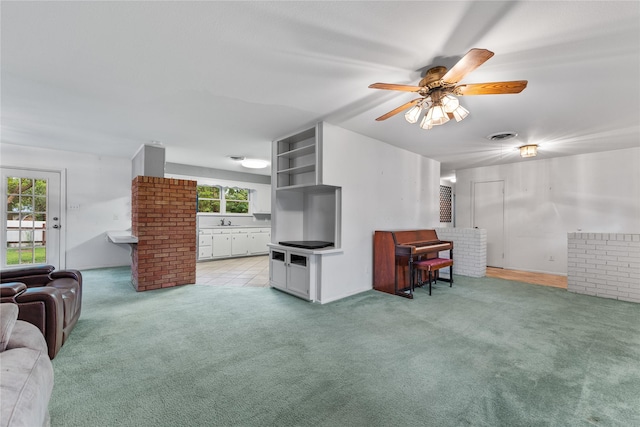 living room with carpet floors, a ceiling fan, and visible vents
