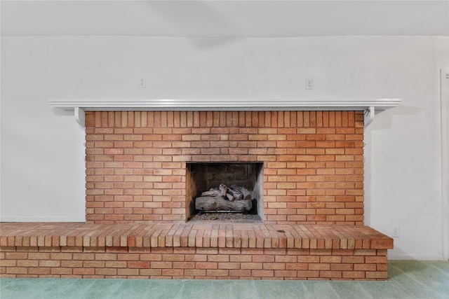 room details with carpet flooring and a brick fireplace