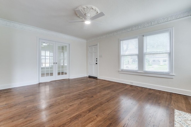 spare room featuring ceiling fan, french doors, crown molding, wood finished floors, and baseboards