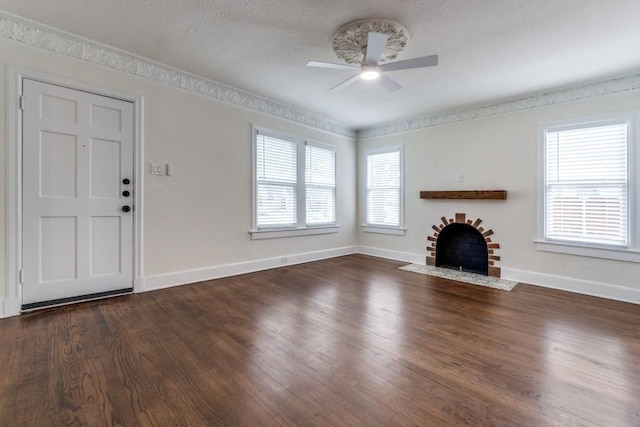 unfurnished living room with a fireplace with flush hearth, baseboards, and a ceiling fan