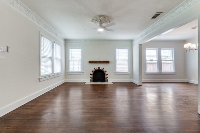 unfurnished living room featuring a fireplace with flush hearth, a wealth of natural light, ceiling fan with notable chandelier, and visible vents