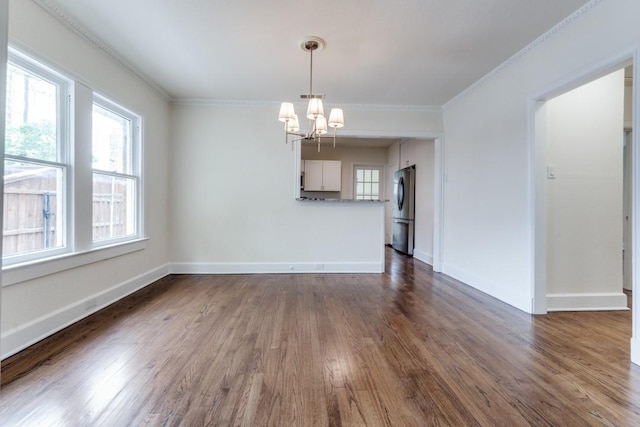 unfurnished dining area with crown molding, baseboards, a chandelier, and dark wood-style floors