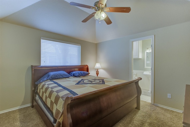 bedroom featuring carpet floors, a ceiling fan, ensuite bath, and lofted ceiling