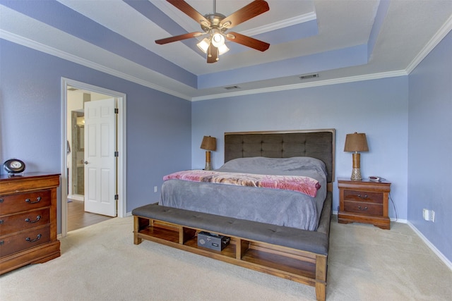 carpeted bedroom with crown molding, baseboards, and a tray ceiling