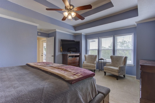 bedroom featuring ceiling fan, light carpet, a tray ceiling, and ornamental molding