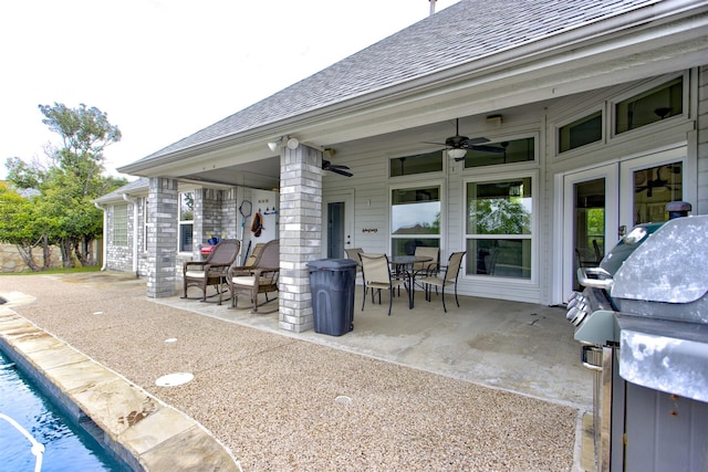view of patio with area for grilling, ceiling fan, an outdoor pool, and outdoor dining space