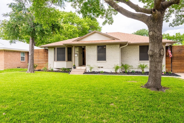 single story home with brick siding, a front lawn, and fence