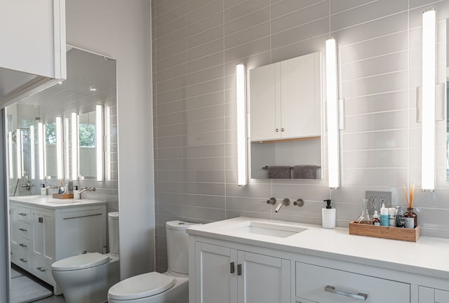 bathroom featuring tile walls, tasteful backsplash, vanity, and toilet