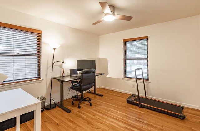 office with baseboards, light wood finished floors, and ceiling fan