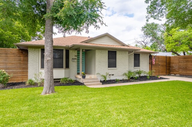 ranch-style home with fence, a front yard, crawl space, and brick siding