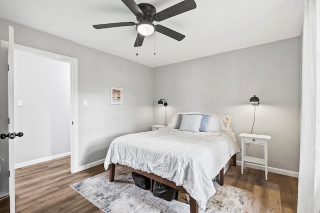bedroom with baseboards, a ceiling fan, and wood finished floors