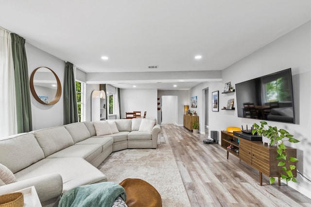 living room with recessed lighting, light wood-style flooring, and visible vents