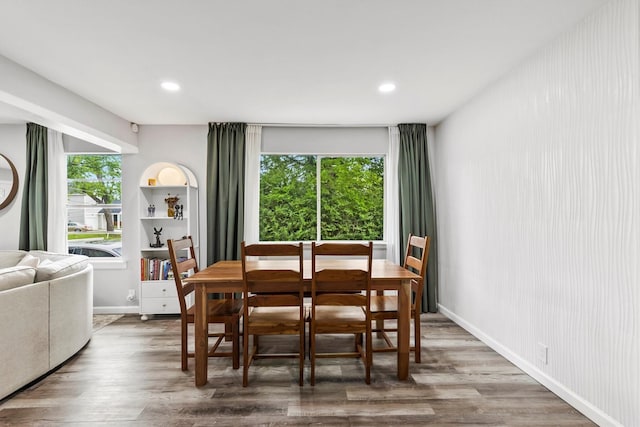 dining space with recessed lighting, baseboards, and wood finished floors