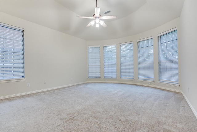 empty room featuring ceiling fan, visible vents, baseboards, and carpet