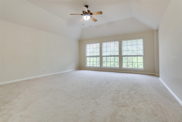 unfurnished room featuring carpet flooring, a ceiling fan, baseboards, and vaulted ceiling
