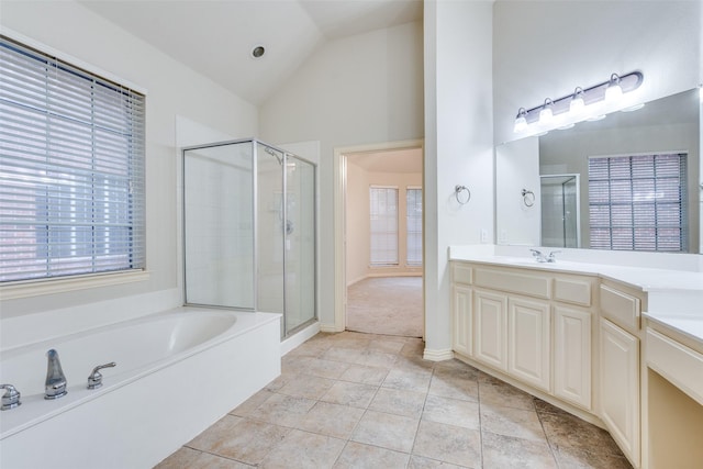 full bathroom with a shower stall, a garden tub, and lofted ceiling