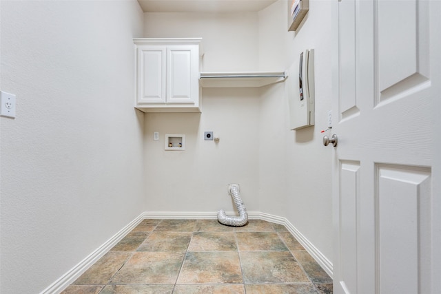 laundry area with cabinet space, hookup for a washing machine, baseboards, stone finish flooring, and hookup for an electric dryer
