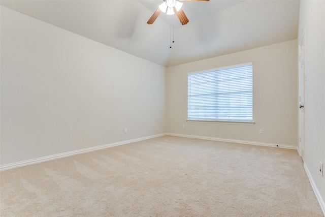 empty room featuring a ceiling fan, baseboards, light carpet, and lofted ceiling