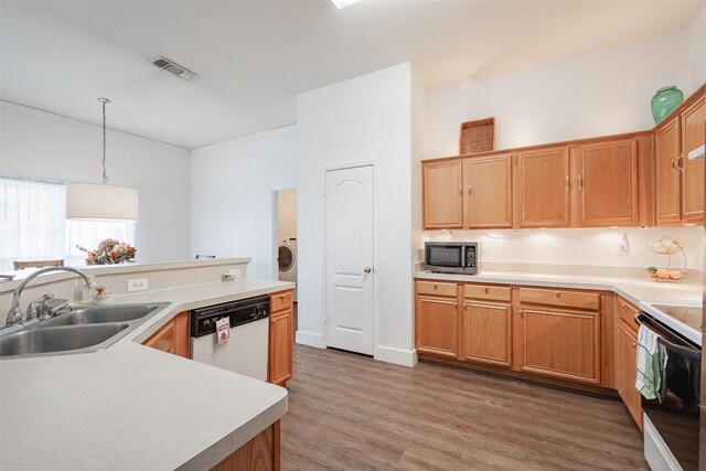 kitchen with visible vents, light wood-type flooring, a sink, light countertops, and white appliances