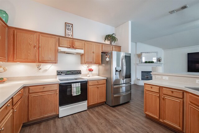 kitchen with range with electric stovetop, visible vents, wood finished floors, stainless steel fridge with ice dispenser, and under cabinet range hood