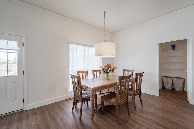 dining area featuring crown molding, baseboards, a wealth of natural light, and wood finished floors