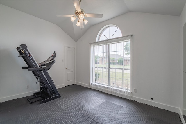 exercise area with a ceiling fan, baseboards, and vaulted ceiling