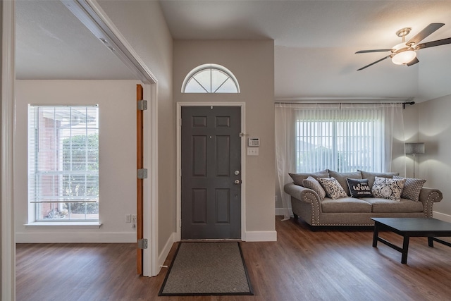 foyer with baseboards, ceiling fan, and wood finished floors