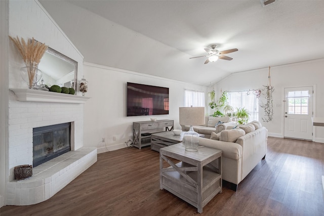 living area with vaulted ceiling, baseboards, a ceiling fan, and dark wood-type flooring