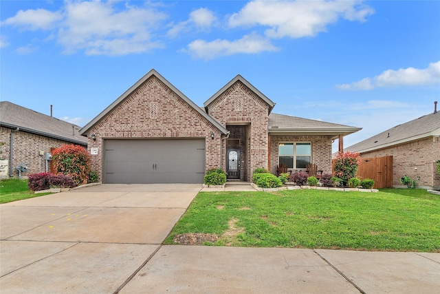 view of front of property featuring fence, a front lawn, brick siding, a garage, and concrete driveway