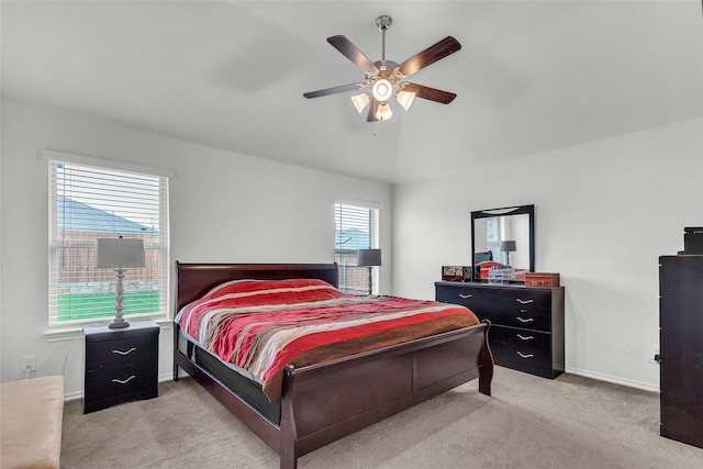 bedroom featuring carpet floors, baseboards, a ceiling fan, and lofted ceiling