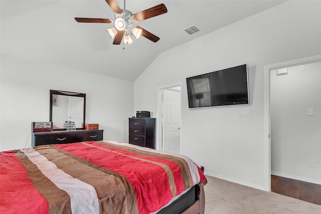 carpeted bedroom with a ceiling fan, baseboards, visible vents, and vaulted ceiling