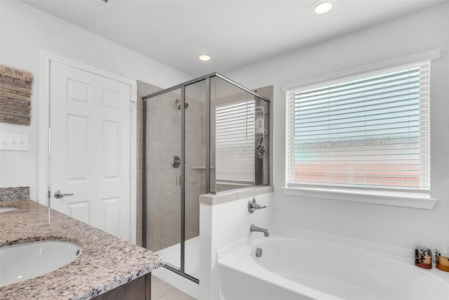 bathroom featuring a bath, a stall shower, and a healthy amount of sunlight