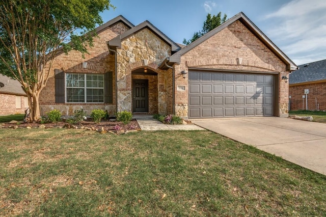 view of front of property featuring a front lawn, stone siding, a garage, brick siding, and driveway